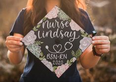 a woman holding up a graduation cap that says nurse lindsey