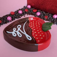 a heart shaped box with chocolate and strawberries on it