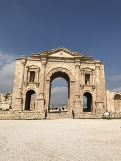 an old stone building with two archways on the front and one in the middle