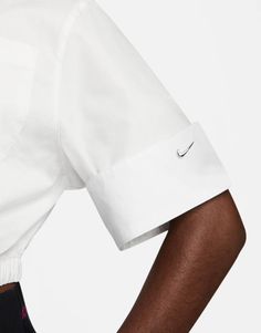 Top by Nike Love at first scroll Spread collar Zip fastening Chest pocket Logo embroidery Elastic hem Regular fit Classic Cropped Shirt With Pockets For Work, Classic Cropped Shirt With Pockets For Spring, Classic Collared Cropped Shirt With Pockets, Nike Collared Tops For Spring, Classic Cropped Shirt With Button Cuffs, White Cropped Tops For Workwear, Nike Classic Collared Tops, Nike Classic Fitted Tops, Classic Nike Collared Tops