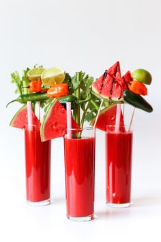 three glasses filled with watermelon juice and garnishes