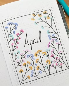 an open notebook with flowers and the word april on it