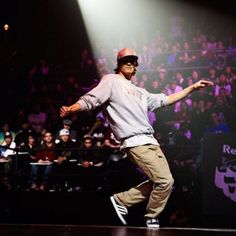 a man is dancing on stage in front of an audience