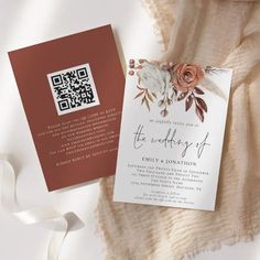 the wedding stationery is laid out on a blanket next to a white and brown ribbon