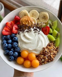 a white bowl filled with fruit and yogurt