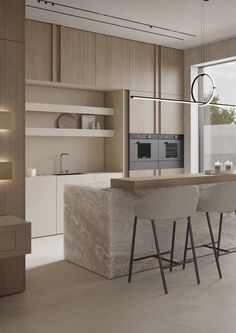 a modern kitchen with marble counter tops and bar stools