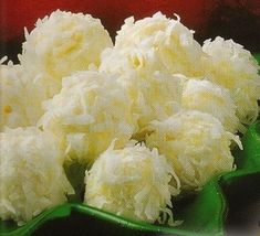 some white flowers are in a green bowl