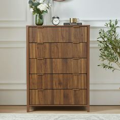 a wooden dresser sitting in front of a clock