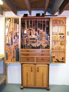 a wooden cabinet with many tools in it