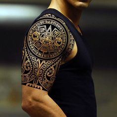 a man's arm with an intricate tattoo design on the chest and shoulder,