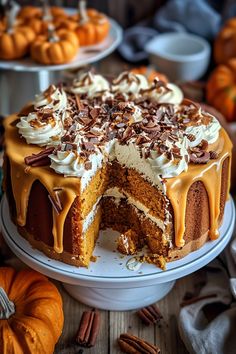 there is a cake that has been cut into pieces and is on the table with other pumpkins in the background