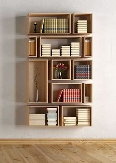 a bookshelf filled with lots of books on top of a hard wood floor