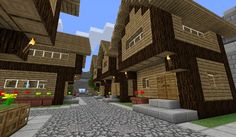 an image of a minecraft village with lots of houses and flowers on the ground