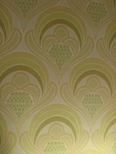 the wallpaper is green and gold with swirls