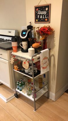 a kitchen area with a coffee maker, microwave and other items on a cart in front of the counter