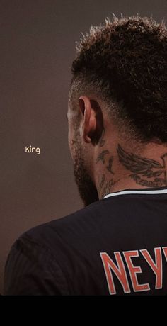 the back of a man's head with tattoos on it