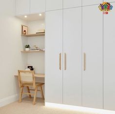 a room with white cabinets and a wooden chair next to a desk in the corner