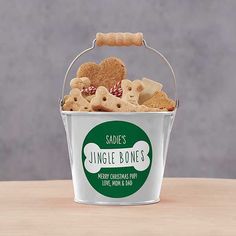 a blue bucket filled with dog treats sitting on top of a table