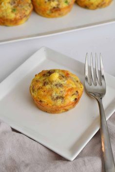 an egg muffin on a plate with a fork next to the muffins