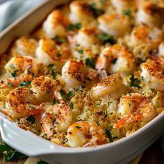 a casserole dish filled with shrimp and cheese