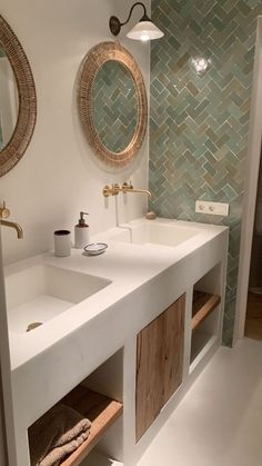 a bathroom with two sinks and mirrors on the wall