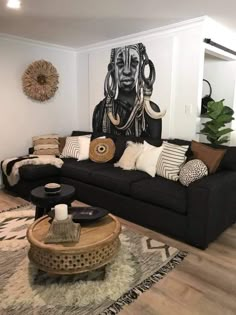 a living room filled with furniture and a large painting on the wall above it's head