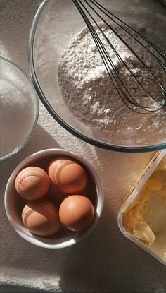 eggs and flour in bowls on a table