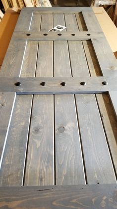 a close up of a wooden table with holes in it