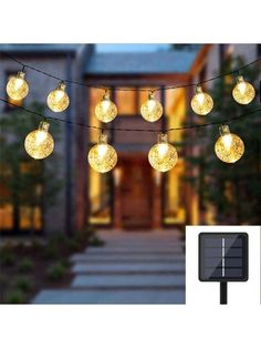 solar powered string lights are hanging from the side of a house