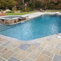 an empty swimming pool surrounded by stone steps