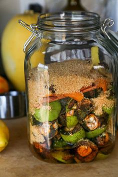 a glass jar filled with food sitting on top of a table