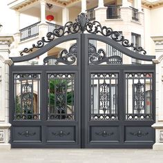 an ornate iron gate in front of a house