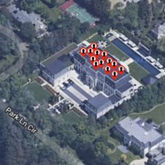 an aerial view of a large house with lots of red dots in the middle of it