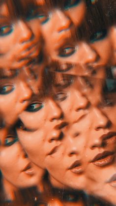 a group of women's faces are shown through a glass window with the reflection of them