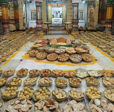 a large room filled with lots of food on top of it's floor covered in plates and bowls