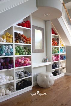 there are many different colors of yarn on the shelves next to each other in this room