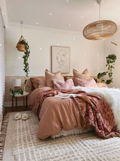 a bedroom with a large bed covered in blankets and pillows