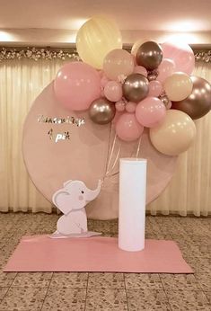 an elephant balloon centerpiece is displayed in front of a pink and white backdrop with balloons