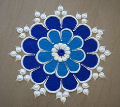 a blue and white flower design on a wooden surface