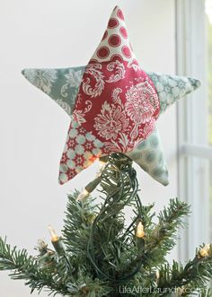 an ornament hanging from the top of a christmas tree