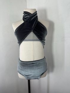 a mannequin wearing a black and grey top