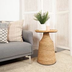 a living room with a couch, chair and table in front of a white wall