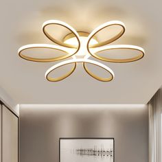 a modern ceiling light with circular lights in a living room or dining room, designed to look like an abstract flower