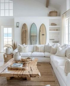 a living room filled with lots of furniture and surfboards on the wall behind it