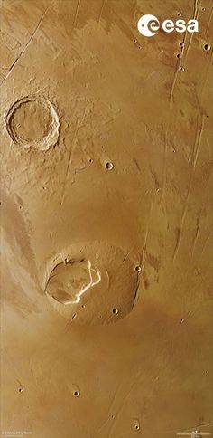 an aerial view of the surface of mars, with two circles in the sand and one circle on the ground