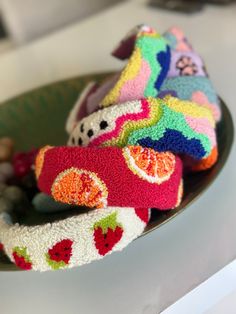 several colorful knitted toys are on a plate