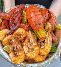 a bowl filled with cooked shrimp and corn on the cob