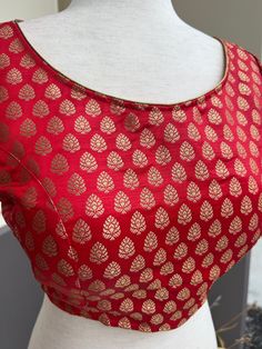 Pure Banarasi Red Color Blouse with small Gold Buttis in Zari Weaving. Comes with Cups attached to the blouse. Please note : Blouses has margin to open 2 sizes up. Item : Ready to Wear BlouseColor : Red Blouse Fabric : Pure Banarasi SilkBlouse Fitting : Princess Cut Lining : Yes, it is fully lined Padded or Non-Padded : Padded Closure: Back Closure with hooks.Ready-to-Wear : YesDisclaimer - :-This is a Standard Size blouse. We do not guarantee perfect fit as every body and shape is different. Li Red Art Silk Blouse For Diwali, Red Zari Weaving Blouse For Festivals, Traditional Brocade Tops With Zari Work, Red Blouse With Zari Weaving For Festivals, Red Art Silk Unstitched Blouse, Red Unstitched Blouse Piece For Transitional Season, Festive Banarasi Silk Tops With Zari Weaving, Red Bollywood Blouse With Zari Weaving, Bollywood Style Red Blouse With Zari Weaving