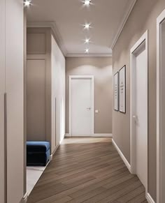 an empty hallway with wooden floors and white lights on the ceiling is lit by recessed lighting