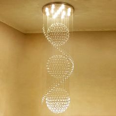 a chandelier hanging from the ceiling in a room with beige walls and flooring